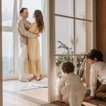 A joyful family moment indoors with parents and children enjoying a cozy home environment.